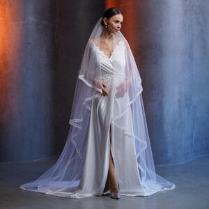 ivory wedding veil, two tier veil, chapel length veil, italian tulle veil, luxury bridal veil, veil with velvet ribbon, elegant wedding veil, classic bridal veil, soft tulle veil, long wedding veil, modern bridal veil, minimalist wedding veil, veil for bride, ceremony bridal veil, timeless wedding accessory, couture bridal veil, formal wedding look, bridal ceremony veil, wedding day veil, elegant bride style