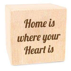 May include: A wooden block with the text "Home is where your Heart is" engraved on it.