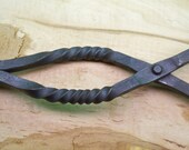 Hand forged fireplace tongs with twists.