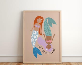 May include: A framed art print featuring two cartoon mermaids. One mermaid has red hair and a blue and white floral tail. The other mermaid is upside down with purple hair and a teal tail. The text "let's be mermaids" is written in a script font.