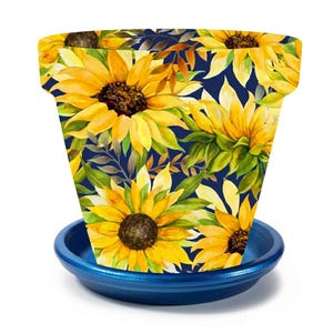 May include: A decorative flower pot with a matching saucer. The pot is adorned with a vibrant sunflower pattern against a dark blue background. The sunflowers are yellow with brown centers and green leaves. The saucer is a solid blue.