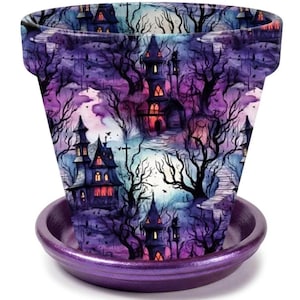 May include: A tapered plant pot with a matching saucer, featuring a repeating pattern of dark, multi-story houses, bare trees, and a full moon against a vibrant purple and blue sky. The saucer has a solid, metallic purple finish.