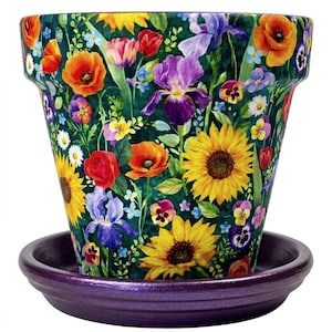 May include: A ceramic flower pot with a vibrant floral design featuring sunflowers, irises, poppies, and other colorful blooms. The pot sits on a matching purple saucer. The pot's design is set against a dark green background.