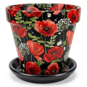 May include: A tapered plant pot with a matching saucer, featuring a black background decorated with a vibrant pattern of red poppy flowers and small white wildflower clusters. The design covers the entire exterior surface of the pot.