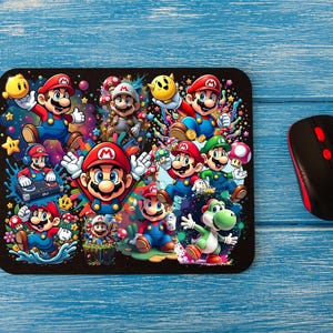 May include: A black mouse mat with a colourful design featuring multiple cartoon characters from the Super Mario Bros. video game franchise. The characters are in various poses and include Mario, Luigi, Toad, and Yoshi.