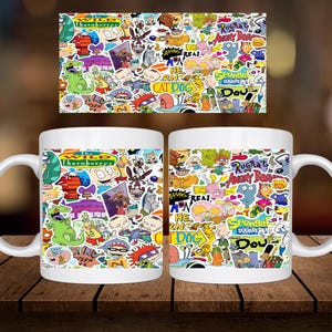 May include: Two white ceramic mugs featuring a colourful cartoon design with characters from popular Nickelodeon shows such as Rugrats, The Wild Thornberrys, CatDog, and SpongeBob SquarePants.
