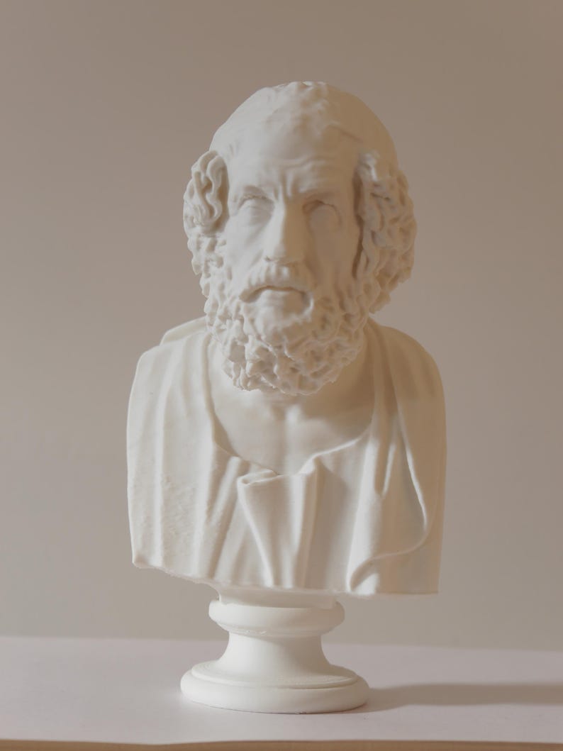  A white bust sculpture of a man with a beard and curly hair. The sculpture is a classical style, with a detailed face and draped clothing. The bust is mounted on a pedestal.