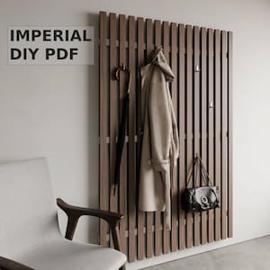 May include: A wooden wall-mounted coat rack with a brown finish. The rack has multiple hooks and is decorated with a coat, an umbrella, and a handbag.