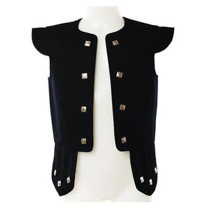 May include: A black, open-front vest with short sleeves and gold square buttons. The vest has a rounded neckline and a fitted waist. The sleeves have a unique, flared design. The vest is displayed on a white mannequin.