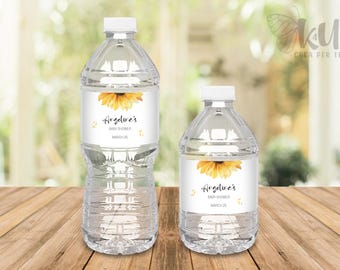 May include: Two clear plastic water bottles with sunflower and text labels. The labels read "Angeline's Baby Shower March 25".