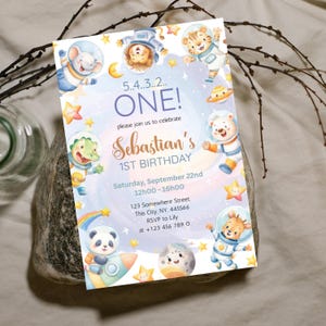 May include: A colorful invitation for a first birthday party. The design features cartoon animals in astronaut suits, stars, planets, and the text "ONE!" and "Sebastian's 1st Birthday". The invitation includes the date, time, and RSVP information.