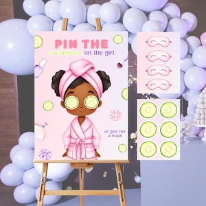 May include: A pink party game sign with the text "Pin the cucumbers on the girl." The illustration features a girl in a spa robe with cucumber slices on her eyes. Additional elements include cucumber slices, eye masks, and a makeup brush.