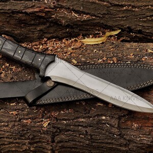 Resident Evil cosplay prop knife laid next to costume gear.