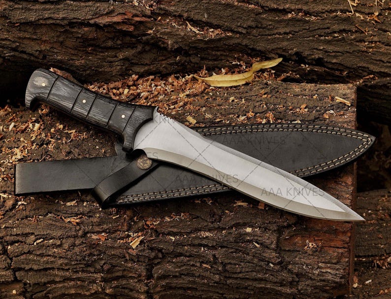 Resident Evil cosplay prop knife laid next to costume gear.