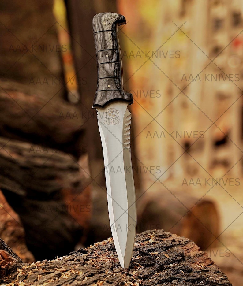 Handmade Resident Evil survival knife displayed on black tactical fabric