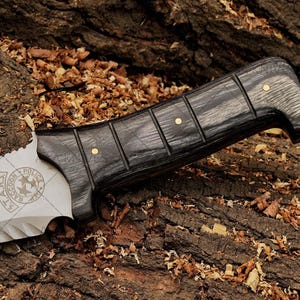 Close-up of wooden handle on custom cosplay knife for Resident Evil fans.