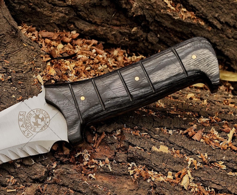 Close-up of wooden handle on custom cosplay knife for Resident Evil fans.