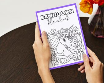 May include: A purple-bordered coloring book with the title "EENHOORN kleurboek" and a black and white illustration of a unicorn with a flower crown.