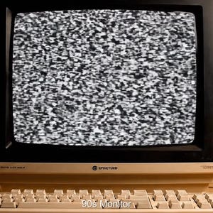 May include: An off-white 90s monitor displaying static, with a matching keyboard and mouse. The monitor has a black frame and the text "90's Monitor" is visible at the bottom of the screen.