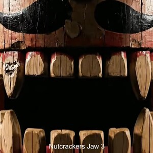 May include: Close-up of a wooden nutcracker with a detailed, aged appearance. The nutcracker features a red and brown painted design, with large, carved teeth and a black mustache. The text "Nutcrackers Jaw 3" is visible at the bottom.
