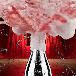 May include: A bottle of sparkling wine erupts in a burst of pink liquid and foam. The bottle is silver and black, with the text "Platinum Pop" visible. The background features red curtains and a wooden floor.