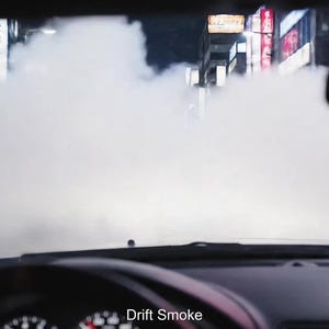 May include: View from inside a car, obscured by a large cloud of white smoke. The dashboard and steering wheel are visible, with the text "Drift Smoke" at the bottom. City lights are visible in the background.