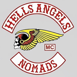 May include: A patch with the Hells Angels logo, showing a skull with a winged helmet. The words "HELLS ANGELS" are arched at the top, and "NOMADS" is at the bottom. The colors are red, yellow, black, and white.
