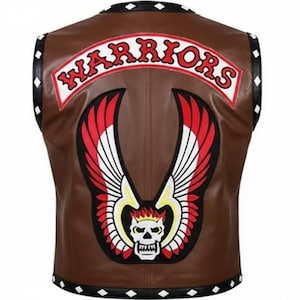 May include: A brown leather vest featuring a black trim with white diamond accents. The back displays a large embroidered patch with the text WARRIORS in red letters above a graphic of a white skull with red and white wings and yellow flames.