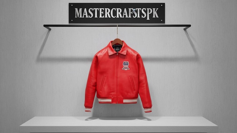 May include: A vibrant red leather jacket with a classic collar and a patch on the chest. The jacket has white and red striped cuffs and a white stripe at the bottom. The sign above reads "MASTERCRATSPSK".