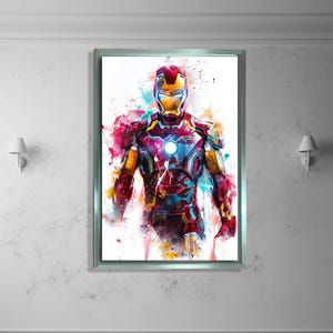K&ouml;nnte beinhalten: Gerahmter Aquarelldruck von Iron Man. Das Kunstwerk zeigt eine lebendige Darstellung des Superhelden in seinem ikonischen Anzug, mit einem dynamischen Farbspritzer in Rot, Gelb, Blau und Pink. Der Druck ist in einem silbernen Rahmen eingefasst.
