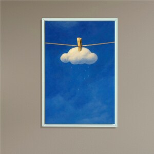 May include: A framed art print depicts a whimsical scene of a fluffy white cloud suspended from a clothesline by a clothespin against a vibrant blue sky. Raindrops fall from the cloud, creating a surreal and playful atmosphere. The artwork is framed in a white border.