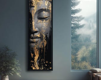 May include: A framed artwork featuring a close-up of a Buddha's face. The face is rendered in shades of black and gold, with gold paint dripping down the black background. The artwork is displayed on a gray wall.