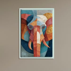May include: Geometric elephant art print in a white frame. The artwork features a colorful, abstract design of an elephant's face, with shades of blue, orange, red, and gold. The elephant's form is created using geometric shapes.