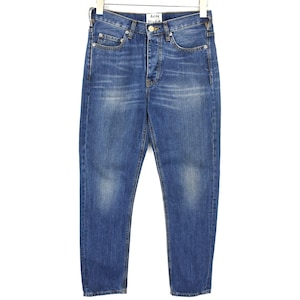 May include: A pair of blue denim jeans with a faded wash, featuring a button fly closure, five pockets, and a white brand label reading Acne Studios at the interior waistband. The jeans have a straight leg cut with visible stitching details.
