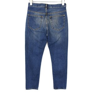 May include: A pair of blue denim jeans shown from the back, featuring a classic five-pocket design with a medium wash, visible stitching, a waistband with belt loops, and a button and zipper fly closure at the top centre of the garment.