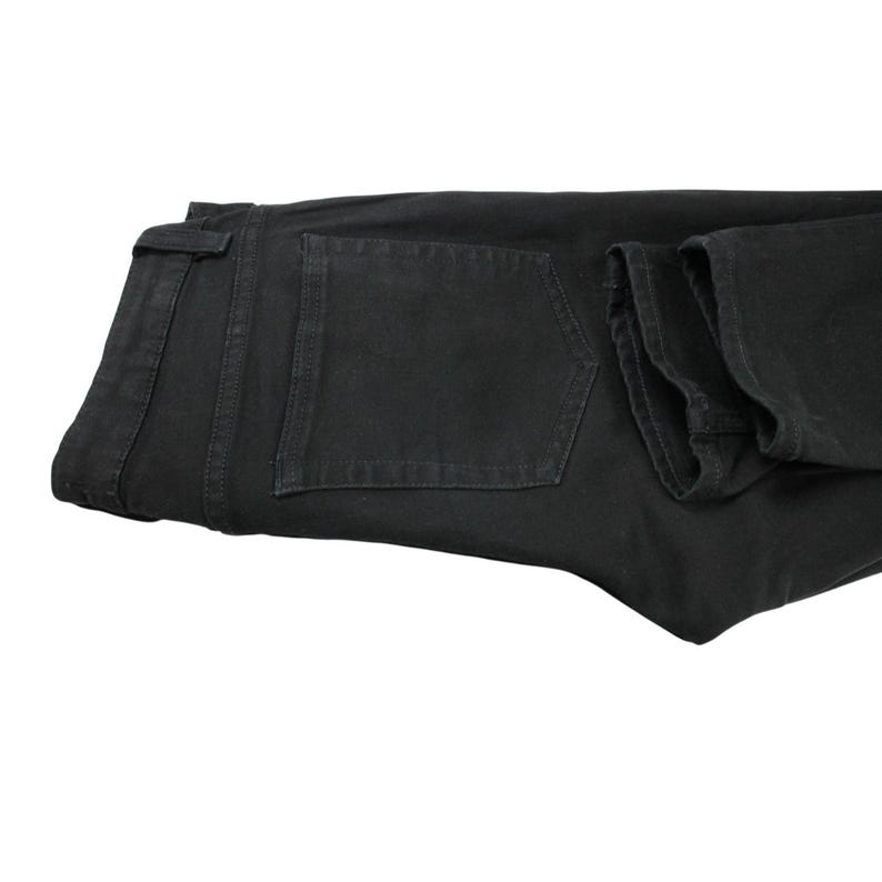 May include: A pair of solid black denim jeans featuring a standard waistband with belt loops, a single visible back pocket with tonal stitching, and a classic straight-leg cut. The fabric has a matte finish and consistent dark coloring throughout.