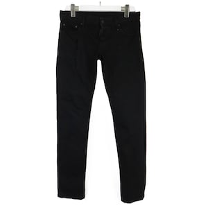 May include: Black denim jeans hanging on a white hanger. The jeans have a classic five-pocket design, a button and zipper closure, and a straight leg fit. The dark wash of the denim provides a versatile look.