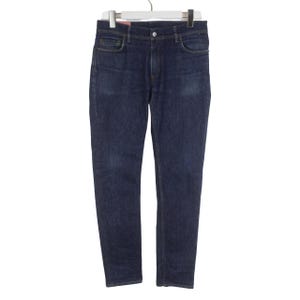 May include: A pair of dark blue denim jeans featuring a classic five-pocket design, a button and zipper fly closure, and belt loops at the waistband. The jeans have a straight-leg cut with subtle fading on the thighs and are displayed on a hanger.
