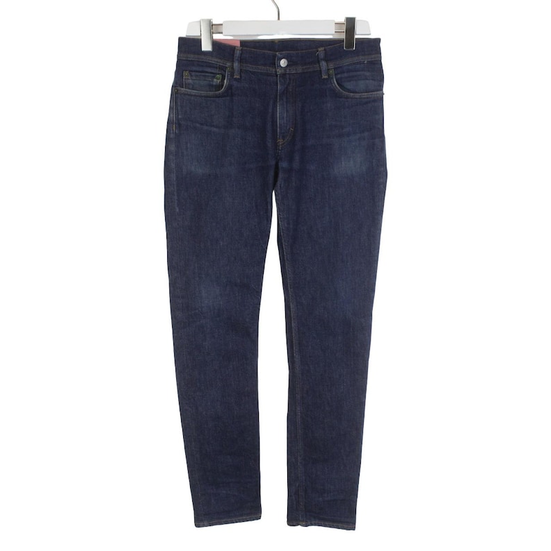 May include: A pair of dark blue denim jeans featuring a classic five-pocket design, a button and zipper fly closure, and belt loops at the waistband. The jeans have a straight-leg cut with subtle fading on the thighs and are displayed on a hanger.