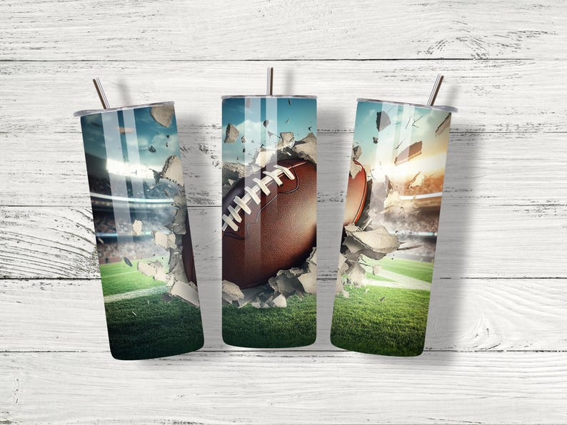 May include: Three stainless steel tumblers featuring a design of a football breaking through concrete. The tumblers are displayed against a white wooden backdrop.