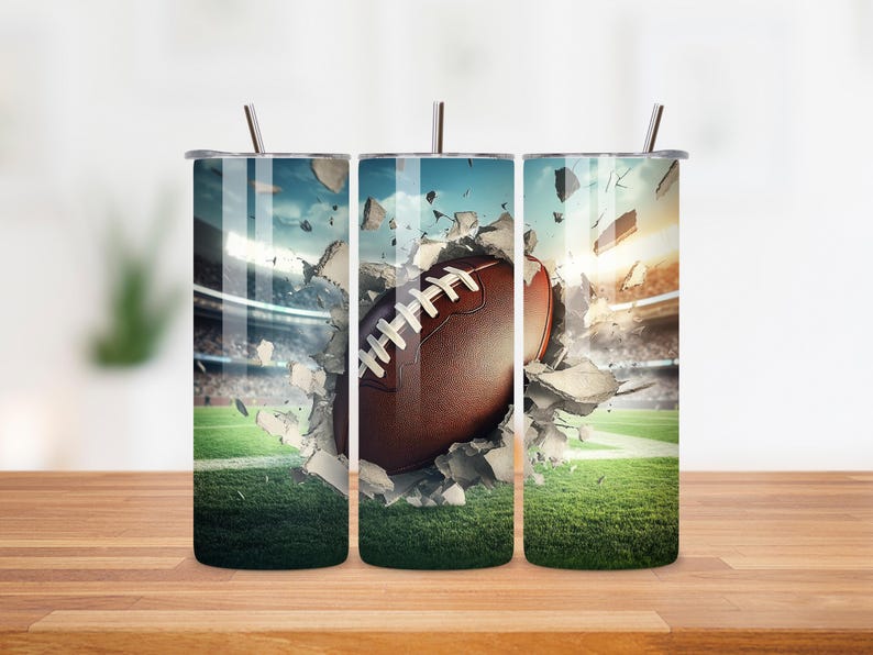 May include: Three stainless steel tumblers with lids and straws. Each tumbler features a different image of a football breaking through a wall of concrete. The football is brown and white.