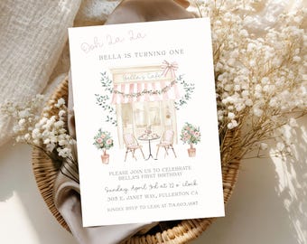 May include: A birthday invitation with the text "Ooh La La" and "Bella is turning one." The invitation features a watercolor illustration of a cafe with pink and white striped awning, flowers, and a table setting. The invitation includes the date, time, and location.