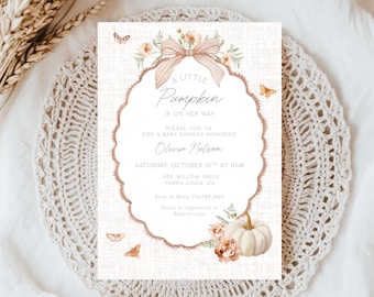 May include: A baby shower invitation with the text "A Little Pumpkin is on Her Way." The design features a pumpkin, flowers, and butterflies in shades of peach and cream. The invitation is on a textured background.
