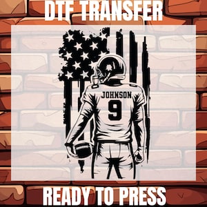 May include: Black and white DTF transfer design featuring a football player with the name "JOHNSON" and the number "9" on the jersey, set against a distressed American flag. The text "DTF TRANSFER" and "READY TO PRESS" are at the top and bottom.
