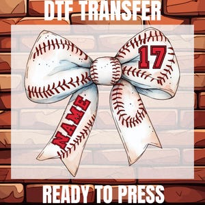 May include: A baseball-themed DTF transfer design featuring a bow made of baseballs with red stitching. The bow has the number 17 and the word "NAME" in red. The text "DTF TRANSFER" and "READY TO PRESS" are at the top and bottom.