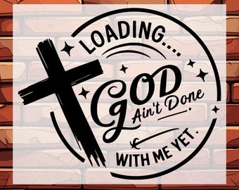 May include: A black and white DTF transfer design with the text "LOADING... GOD Ain't Done WITH ME YET." A black cross is on the left side of the design. The words "DTF TRANSFER" and "READY TO PRESS" are at the top and bottom.