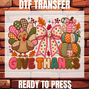 May include: A DTF TRANSFER READY TO PRESS graphic featuring a turkey with patterned feathers, a large polka dot bow, and a stack of three patterned pumpkins. The text GIVE THANKS appears in colorful, stitched-style letters below.