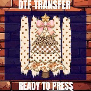 May include: A DTF TRANSFER READY TO PRESS graphic featuring a stylized Christmas tree with a gold star and pink bow. The tree layers display floral, leopard print, brown gingham, and polka dot patterns against a background of vertical brush strokes.