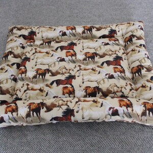 May include: A rectangular beige dog bed with a brown, white, and black horse print. The bed has a raised edge around the perimeter.