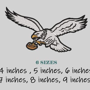 May include: Embroidered design of an eagle in flight, clutching a football. The eagle is white with black wingtips and a yellow beak. Text below reads "6 SIZES" and lists sizes from 4 to 9 inches.